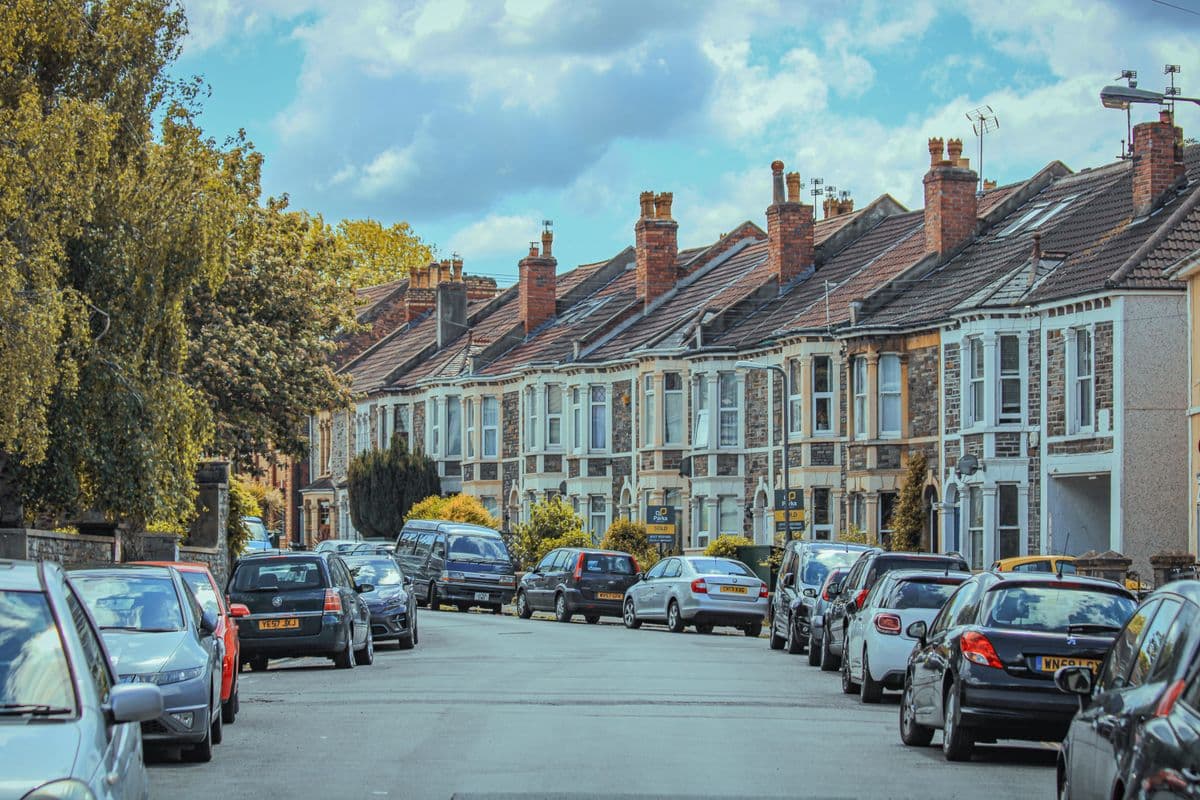 A residential street of typical British Victorian terraced houses